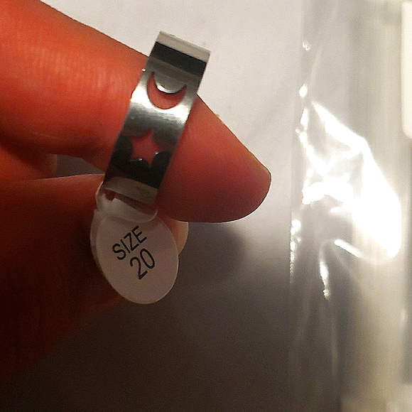 A stainless steel fashion ring with the moon 🌙 and a  star 🌟 shape on it - Picture 2 of 3